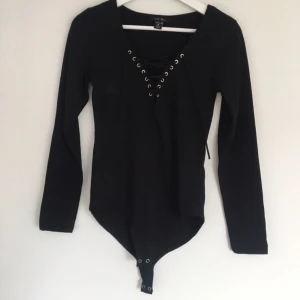  - Svart body med knäppe mellan benen, aldrig använd