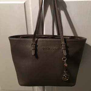  - MK väska. Liten och brun/grå. Guldiga detaljer. 250 kr. Tar swish!