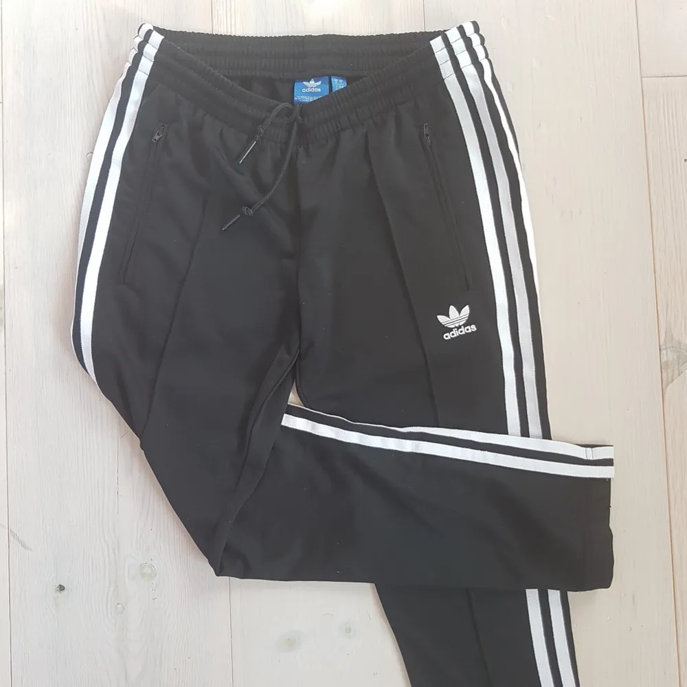 Ett par helt oanvända, svinsnygga Adidas-brallor med superballa pressveck längs med benen. Nice fickor och dragkedjor i benslutet.  Står storlek 36 på lappen, men jag skulle säga att de snarare lutar åt storlek 34.. Jeans & Byxor.