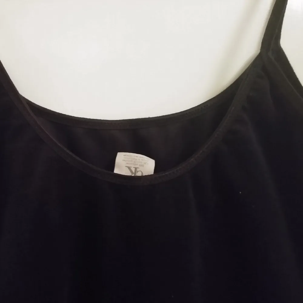 Black velvet top, it has a low back and elastic stripes. Calvin Klein original.   *Normal shipping is included in the price. . Toppar.