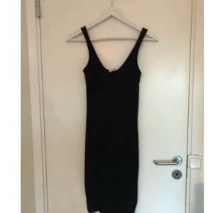  - Svart stretchig figursydd basic klänning. Aldrig använd. 