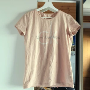 Calvin Klein T-shirt  - Calvin Klein T-shirt storlek L, litet hål vid armhålan annars i fint skick, går enkelt att laga