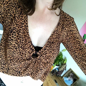Leopard topp - Topp från Urban outfitters, använd ett par gånger bara så i mycket bra skick. Den är plisserad och har utsvängda ärmar. Ganska urringad med en ring där fram 