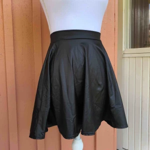  - Svart kjol i läderimitation. Använd 1 gång. Säljes då det inte var min stil. Frakt 63kr