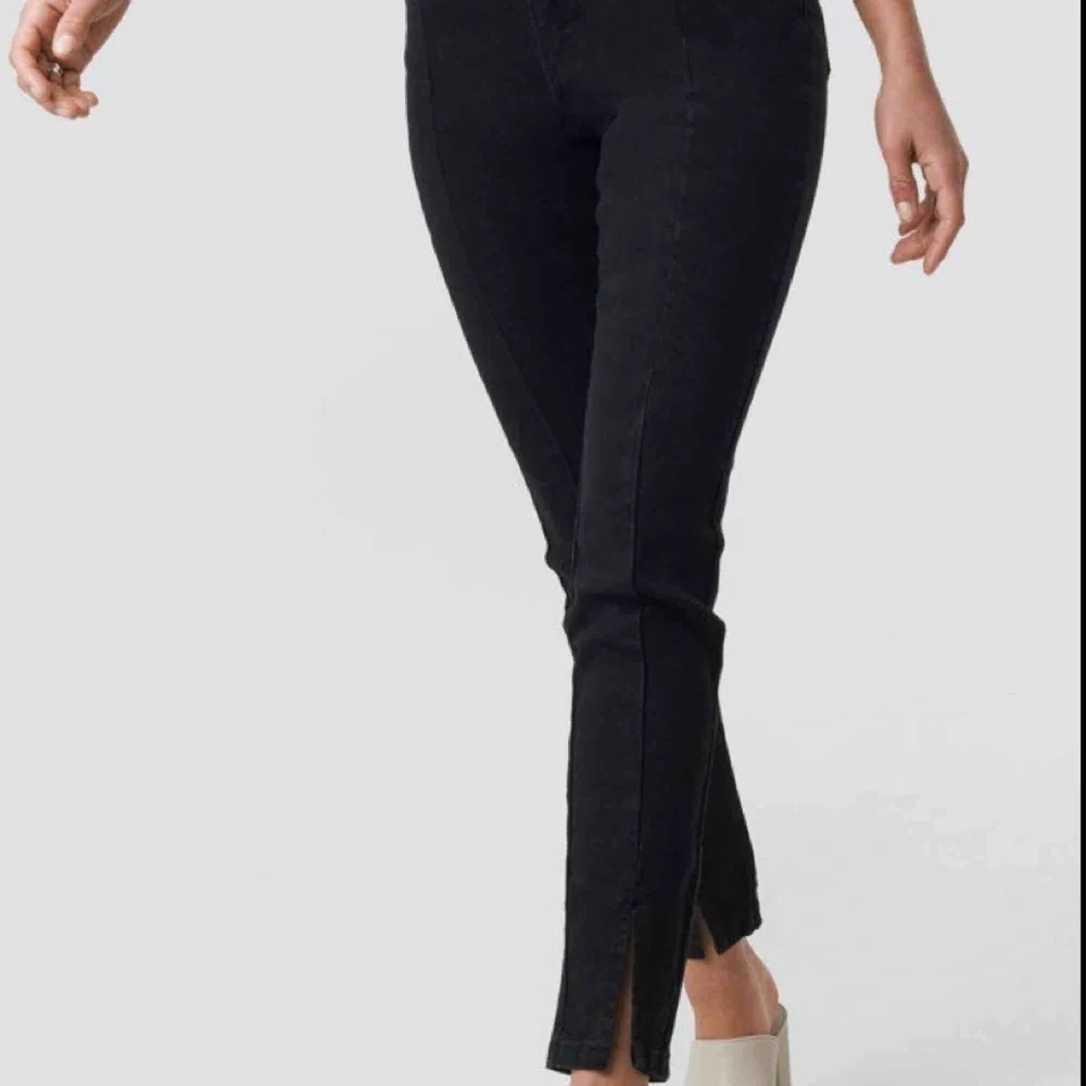 Helt oanvända, super snygga NA-KD svarta byxor med slits. Jeans & Byxor.