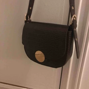  - Snygg brun väska! Som man ser på bilden är materialet lite ”orm” liknande. 