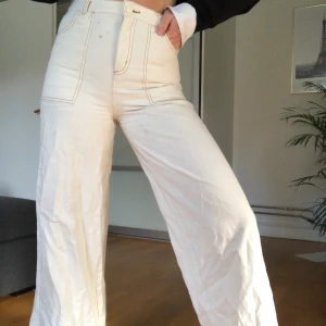 Vita byxor med sömmar från Monki  - Säljer mina asballa byxor från Monki då de tyvärr inte kommer till användning längre + att de är lite för små på mig!! Köpte för 1 1/2 år sedan och är knappt använda!! På bilderna är byxorna inte strukna så ha överseende med att de är lite skrynkliga!! Hör av er om ni har fler frågor!💜