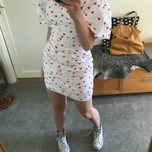 Klänning  - Vit klänning med röda hjärtan från Elsas kollektion med bikbok! Alldrig använd förut. Säljer för lägst 250kr.❤️ buda