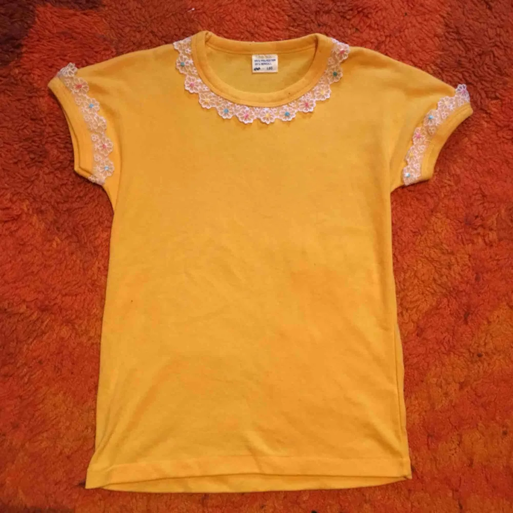 Supergullig t-shirt från 70-talet! Knappt använd, jättemjuk bomull med jättefina spetsdetaljer🌼 säljer pga har redan en likadan! Står att det är barnstorlek 150, som är som en xs⭐️. T-shirts.