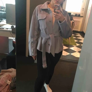  - Jättefin och helt ny lilla jacka/kapp (kort modell)! Stilen är väldigt ny och fräsch. Väldigt skönt och mjuk material! Kommer med matchande bälte  Blixtlåstdetalj nere på armarna  Aldrig använd! 