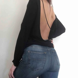  - Svart tröja med öppen rygg. Justerbart band.