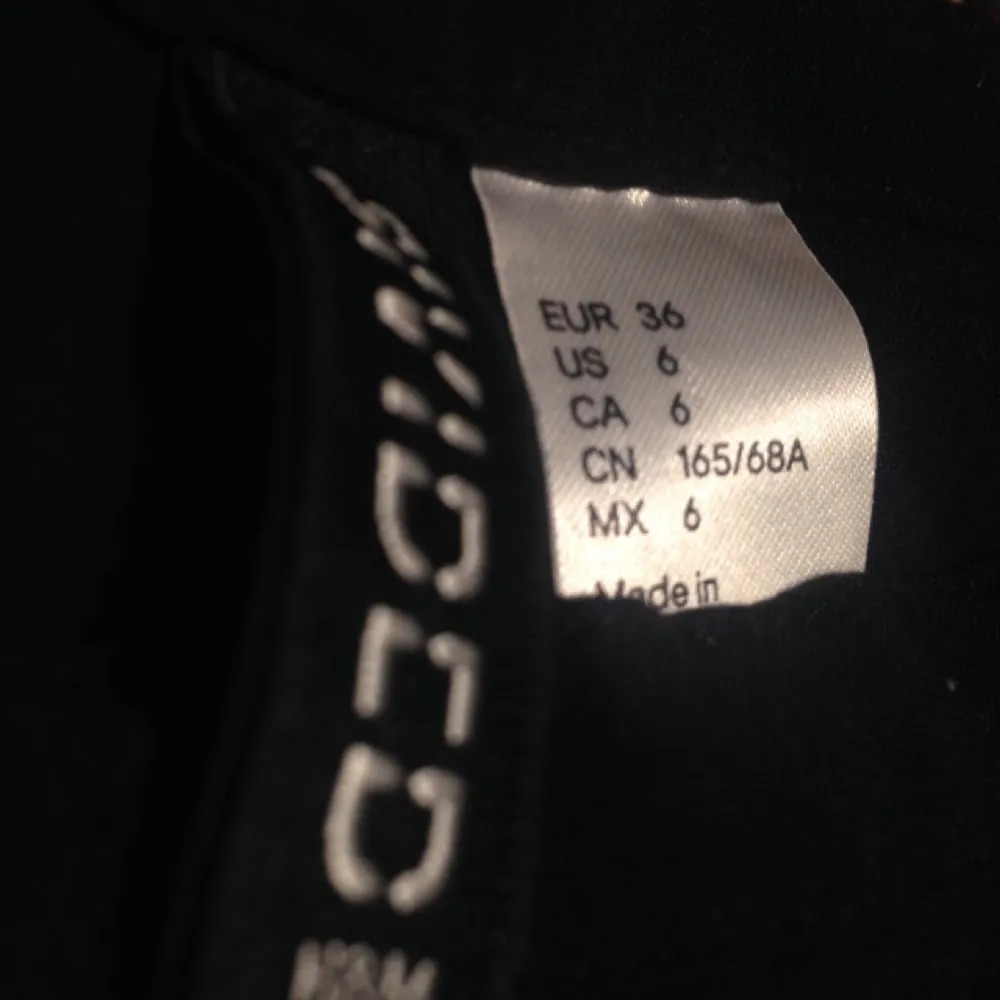 En kort svart kjol med knäppning på framsidan från H&M. Sparsamt använd. På den andra bilden ser den lite gråaktig ut men den är svart:) . Kjolar.