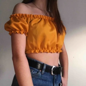 Gul topp med puffärmar - Fin och somrig topp i senapsgult med puffärmar och bekväm passform.  Frakt tillkommer