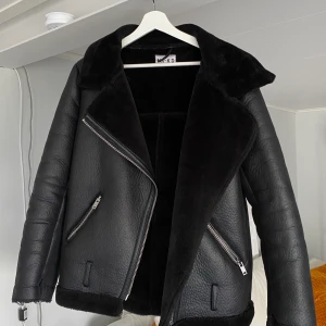 Svart fodrad bikerjacka  - Svart fodrad bikerjacka. Hängaren i nacken är av men går lätt att sy. Skärp medkommer även fast det inte finns på bild. Frakt tillkommer. 