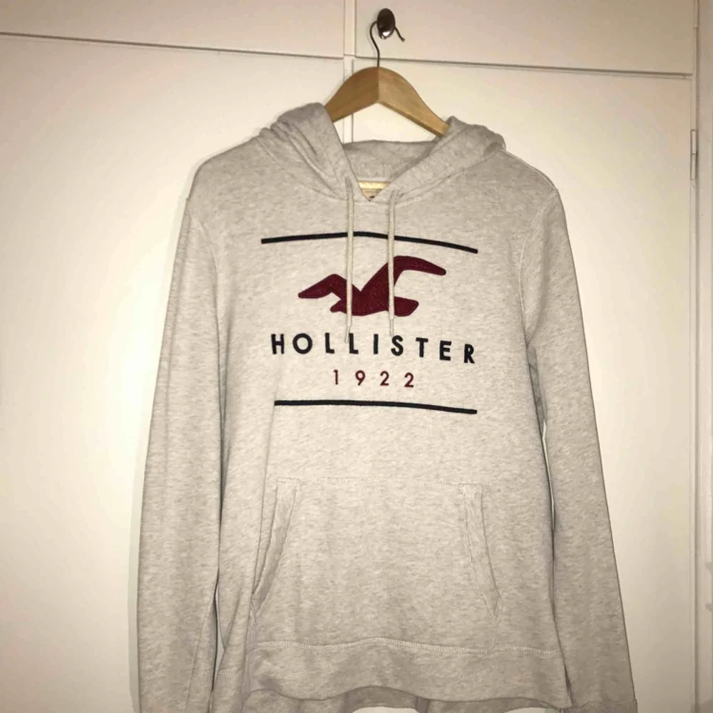 Beige hoodie från Hollister med vinröd logga framtill. Tröjor & Koftor.