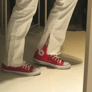 Vita jeans med slits - Vita jeans med slits från Hanna Schönbergs kollektion med NaKd! Storlek 38. De är på gränsen till för korta för mig som är 175 cm lång. Skicket är som nytt🥰