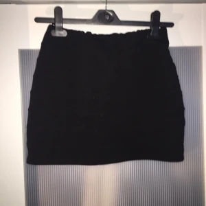  - Kort svart stretchig kjol med dragkedja på baksidan :) aldrig använd 