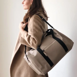 Beige color travelling/gym bag by Rains - Beige color travel bag made by Rains. Spacious, waterproof, and super stylish bag. Measurements: 51x26x21.