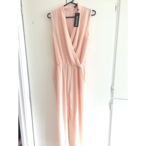  - En rosa/blush färgad jumpsuit från boohoo. Färgen går ej att köpa längre på hemsidan. Dragkedja i ryggen. Skulle haft den på dop men är för genomskinlig vid ben/rumpa för min del. Frakt tillkommer, Swish finns. Priset kan diskuteras!