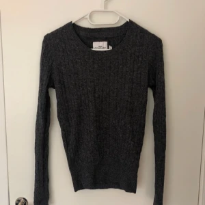  - Mörkgrå kabelstickad tröja från H&M. I strechigt material. Använd en gång så fint skick. 