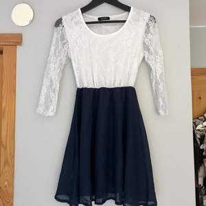 Supersöt klänning med vit spets topp och mörkblå kjol, i storlek S.