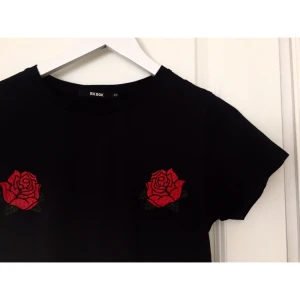  - Svart T-shirt med fina detaljer över bröstet från BikBok, använd fåtal gånger