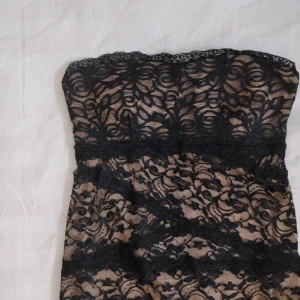  - Kort spetsklänning från Bebe i strl S, använd en gång och är i fint skick. Har tjockare tyg under spetsen och tunt trasparent tyg bredvid dragkedjan bak på ryggen. Halterneck-band medföljes. Kan skicka fler bilder vid intresse!