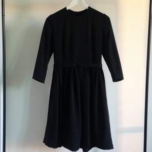 Black dress made by me. Fitted upper part with 3/4 length sleeves. Zipper in the back. Very good material.