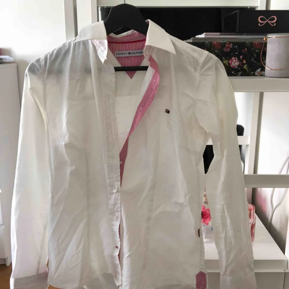 Snygg skjorta med rosa detaljer från Tommy Hilfiger, sitter rätt så tajt om kroppen men formar sig snyggt. Hyfsat gott skick, köparen står för frakt💖. Skjortor.