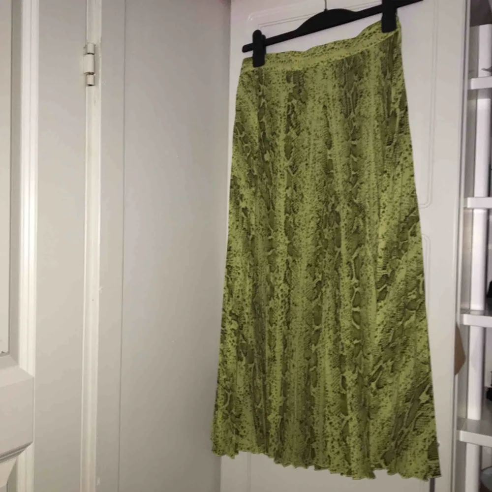 Grön färgad kjol i orm mönstrat tyg. Köpt från Weekday och aldrig använd. Skriv så skickar jag fler bilder och även hur den sitter på<3. Kjolar.