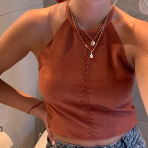 Top från Gina Tricot - Säljer denna läder brun/röda topp från Gina Tricot i storlek Xs, den passar också S. Den är aldrig använd och därför säljer jag den. Nypris 400kr, säljer för 150.  INKLUSIVE FRAKT ! (alltså är frakten redan inräknad i priset)