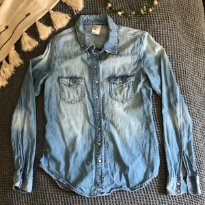 Jeansskjorta - Snygg jeansskjorta i ljus denim. Frakt betalas av mottagare. 