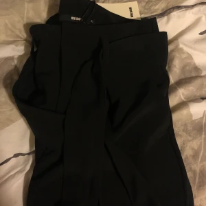 Vida kostymbyxor från BikBok - Vida kostymbyxor med knytning i midjan från BikBok, storlek XS. Prislapp kvar, aldrig använda💫 Skriv för fler bilder/bilder med byxorna på🥰 nypris 400 kr