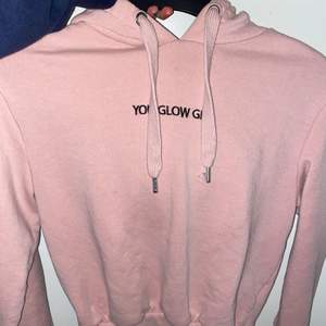 Rosa hoodie med texten ”you glow girl”. Den har en luva och gosigt material, tyvärr kommer den inte till användning längre
