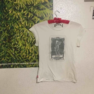  - Gammal Levi’s-tisha med tryck fram och bak. Sitter tight på en S. Det finns flera i samma ”serie” med olika figurer på framsidan .