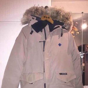  - Beige Canada Goose i mycket bra skick. Storlek 2XS. Kemtvättad. Inköpt för 6000kr.  Väldigt stor i storleken, passar upp emot M. Defekt vid muddarna, går att åtgärdas.   Uppe på flera säljsidor, först till kvarn!  Se gärna mina andra annonser :) 
