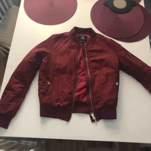  - Vinröd bomberjacka från Chelsea som är helt oanvänd 