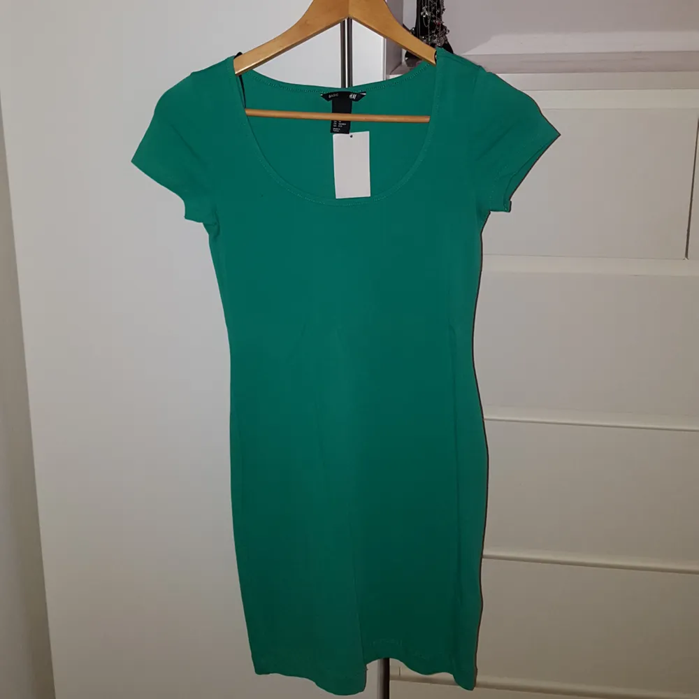 Grön tight klänning från H&M Basic  Oanvänd - Nyskick - Prislapp kvar. Klänningar.
