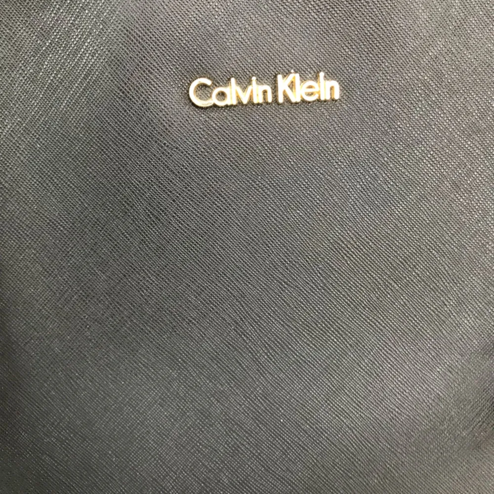 Äkta Calvin Klein väska med gulddetaljer. 35*22*12. Flera fack inuti. Kan skickas mot porto. . Väskor.