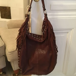  - Läderväska från Zara med snygga fransar och silver ”stud” detaljer. I gott skick, har använts få ggr. 100% läder och bomull inuti. Hämtas i city, Swish föredras