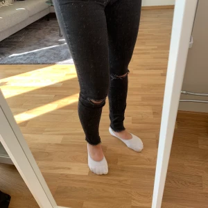 Fina och sköna jeans. Storlek 34 - Svarta jean med hål på båda knäna. Low waist. Använda fåtal gånger 