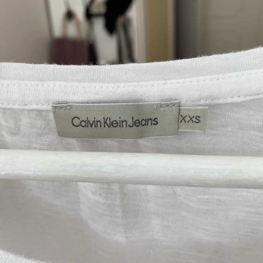 Vit T-shirt från Calvin Klein med tryck där det står ”Calvin Klein jeans” i fina färger. Den är i storlek XXS men är stor i storleke. Den är i fint skick. Vi kan diskutera hur vi gör med frakten annars kan den hämtas i Sundsvall 📍 🧚🏼. T-shirts.