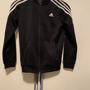 Adidas zip hoodie strlk 152. ( dragkedja)  - Säljer denna adidas zip hoodie, adidas hoodie med dragkedja. Den är i superbra skick och är äkta. Storlek 152 EU.