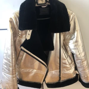 BlankNyc päls med guld överdrag  - Päls med guld överdrag från BlankNyc. Jackan är köpt i USA och bara använts ett fåtal gånger. Det är storlek XS men är ganska stor i storleken så skulle mer säga att det är en S/M.