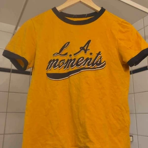  - Cute tomboy top and tight on the body. Looks great with dark or light ripped jean shorts and white sneakers.  Casual attire. 