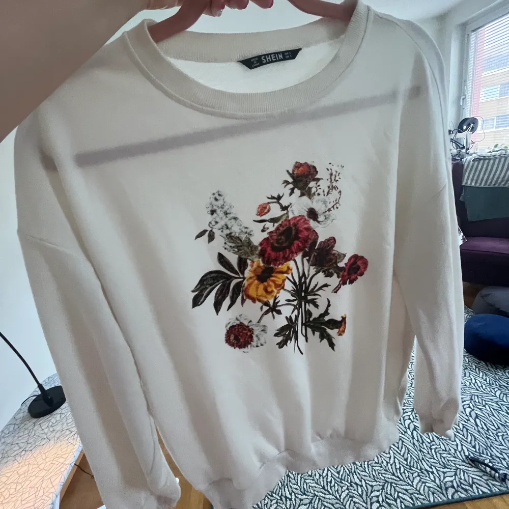 White blouse with lovely flowers print . Hoodies.