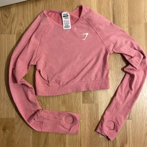 Gymshark vital seamless 2.0 long sleeve crop top - Gymshark vital seamless 2.0 long sleeve crop top i färgen pink marl. Fint skick, knappt använd. 🌸