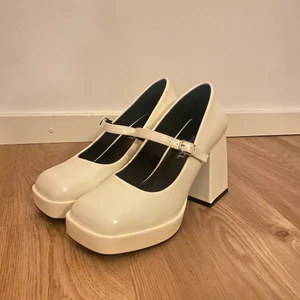 Vita Klackskor - Säljer dessa urgulliga vita klackskor från Monki! Köpte de för att ha till balen. Säljer pga att de är lite för stora för mig tyvärr. Nypris 399kr. Aldrig använda.