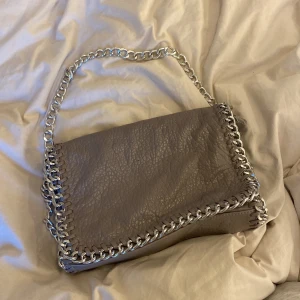 Grå axelremsväska Tiamo - En grå väska i bra skick från Tiamo som ej används längre