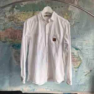 White Carhartt shirt. Two small holes shown in photos.